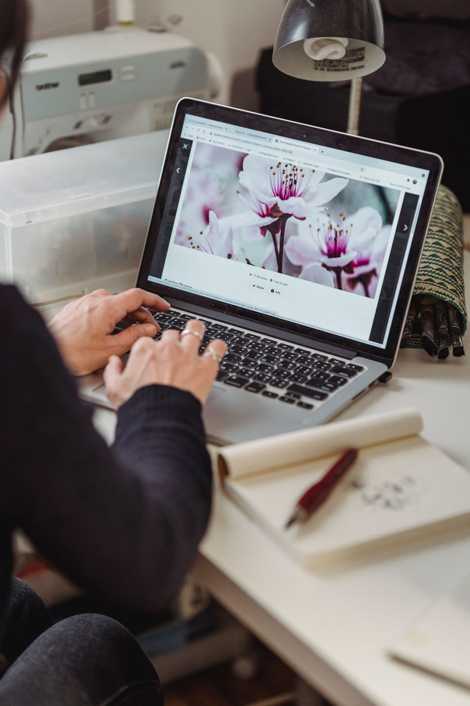 Someone typing on a laptop with a website open in the browser