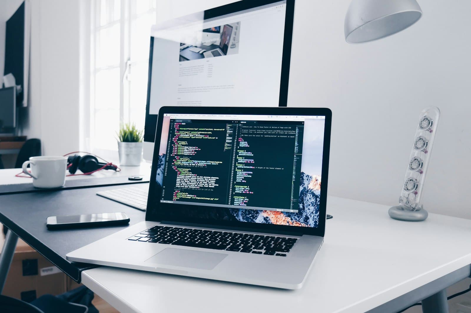 Laptop and notebook on a professional desk