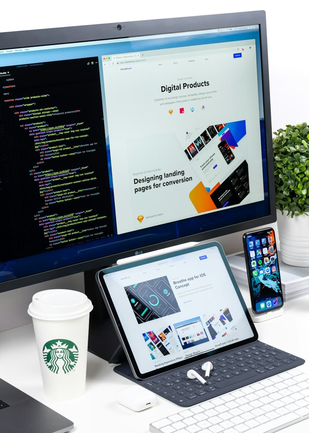Desktop monitor showing a polished business website alongside design work